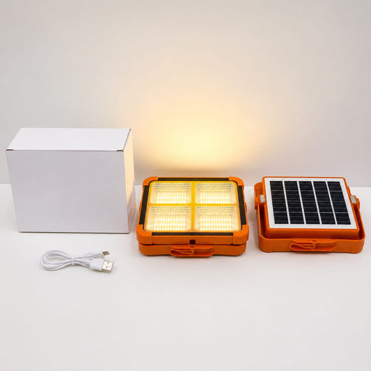 Orange portable light with solar panel and white box on a white background